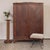 Elegant oak armoire from France, 1930's. Beautiful matched chevron oak wood veneer doors. Sliding doors open to a single...