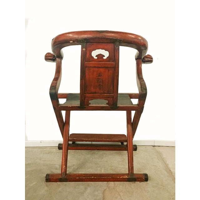 Antique Japanese Buddhist abbot's oxbow arm folding chair. Made of red and gilt lacquer hardwood, with seat made of...