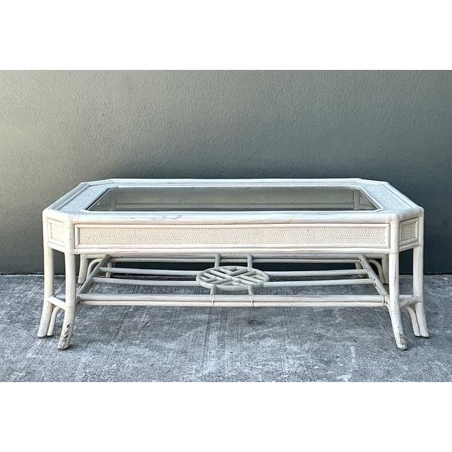 Capture the essence of breezy, elevated living with this vintage Hollywood Regency rattan coffee table. Defined by its...