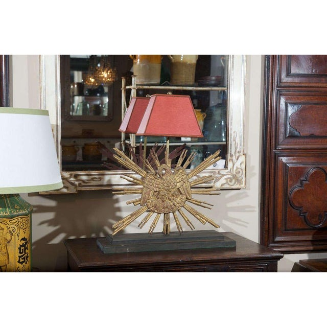 Carved giltwood sunburst mounted as a lamp; French circa 1890.