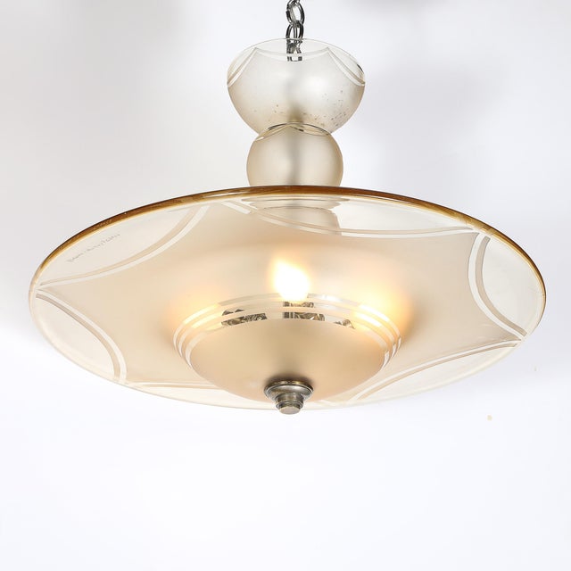 This elegant Art Deco Signed Daum Frosted Rose-Hue Saucer-Form Pendant Chandelier originated in France, circa 1935. The...
