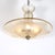 This elegant Art Deco Signed Daum Frosted Rose-Hue Saucer-Form Pendant Chandelier originated in France, circa 1935. The...