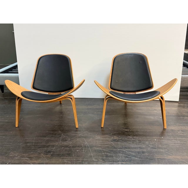 Design Plus Gallery presents a Pair of Shell Chairs in the style of Hans J. Wegner. This pair draws from the iconic three-...