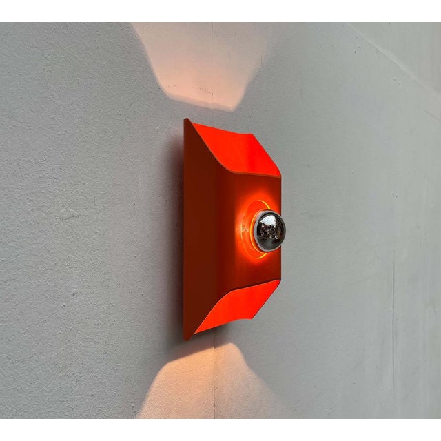 Wall light by Kaiser Leuchten in a bold orange tone, based on a design by Klaus Hempel from the 1970s. Space Age wall...