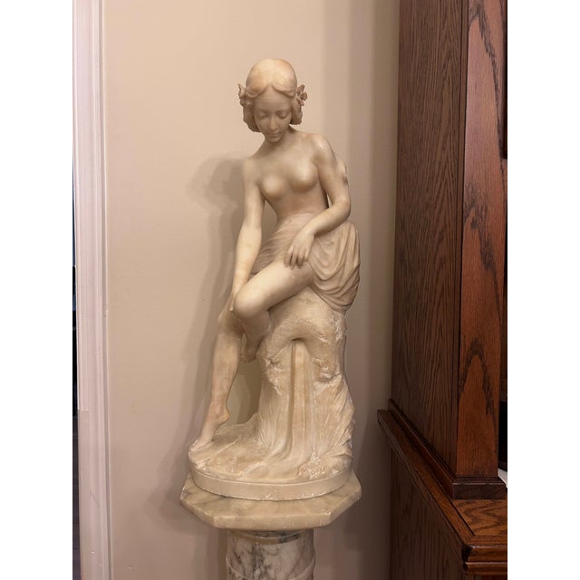 An exquisite late 19th / early 20th century Italian hand-carved alabaster sculpture of a semi-nude classical female maiden...