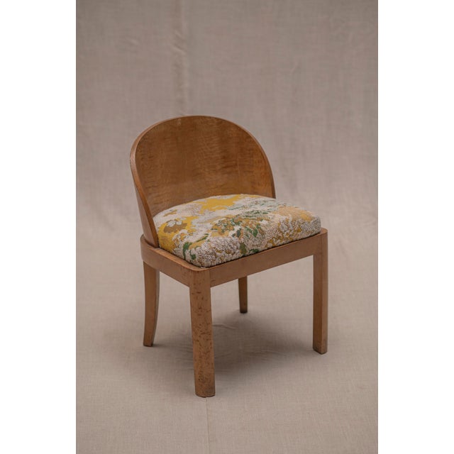 Elegant French Art Deco side chair dating from the 1930s–1940s, featuring a beautifully curved wooden backrest and a...