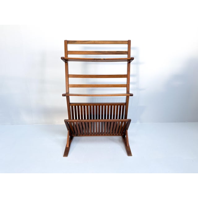 This mid-century modern bookshelf and magazine rack is made from walnut wood, dating back to the 1960s. The piece has a...