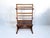 This mid-century modern bookshelf and magazine rack is made from walnut wood, dating back to the 1960s. The piece has a...
