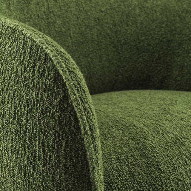 The Sweet armchair features a sculptural, rounded design inspired by a spherical form with a carved-out seat reminiscent...