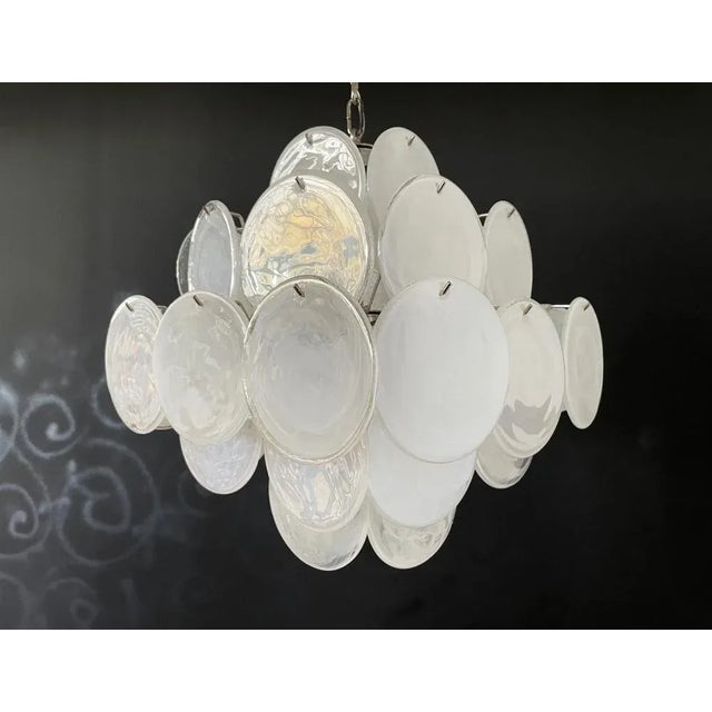 Vintage Italian Murano chandelier in Vistosi style. The chandelier has 36 fantastic iridescent alabaster white discs in a...