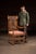 19th century Heavily carved wooden armchair with barley twist supports, pierced crest rail, and carved figural decoration...