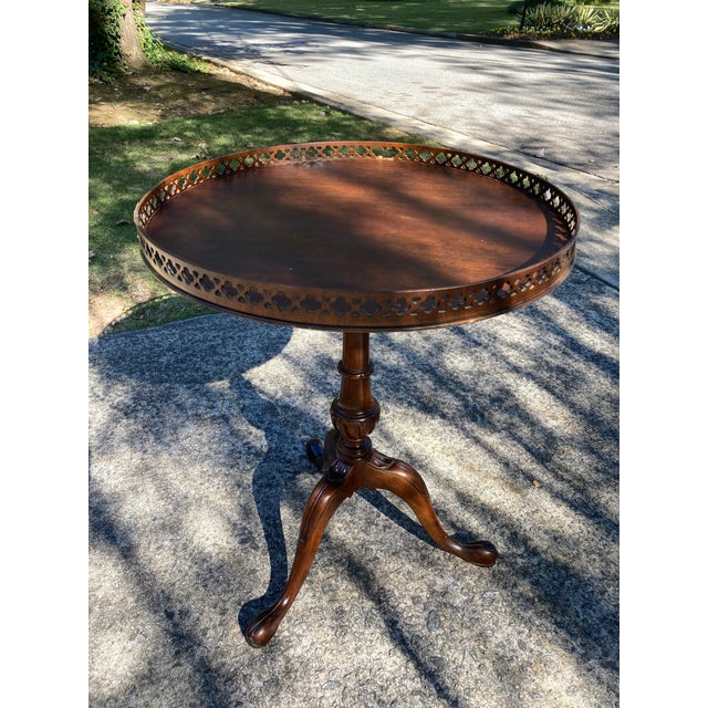 A beautifully crafted mahogany tea table in the George III style by Weiman. Retaining the original label and dating from...