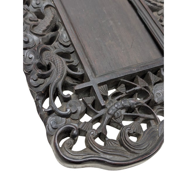 Antique dark wood carved frame, featuring a dragon and fish motif.