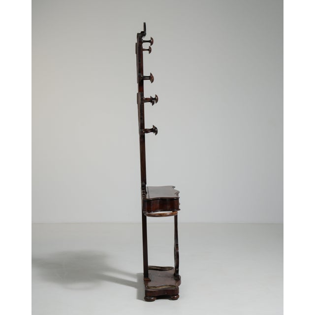 This 19th century Victorian coat rack from United Kingdom is finished in brown, worked in mahogany. Its design carries the...