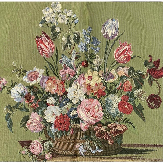 Beautiful traditional Flemish tapestry features a brightly colored flower basket on a soft avocado green background, based...