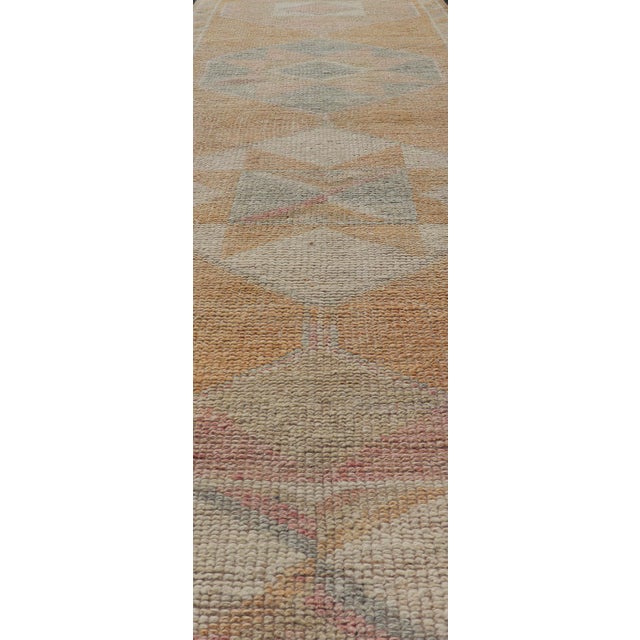 Measures: 2'9 x 12'0 This very unique Oushak is uncommon in its design, from the bright and creamy orange background to...