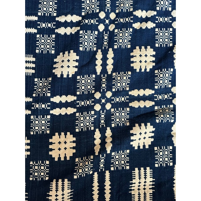 This is a beautiful 19th-century hand loomed blue and white coverlet with a fringed bottom edge. The antique textile is an...