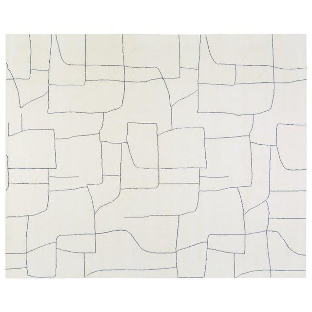 Hand-knotted with care using traditional rug-making techniques, this wool rug blends timeless craftsmanship with a modern...