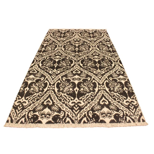 This elegant hand knotted rug features a modern fusion of beauty, with its interlocking geometric and minimalist pattern....