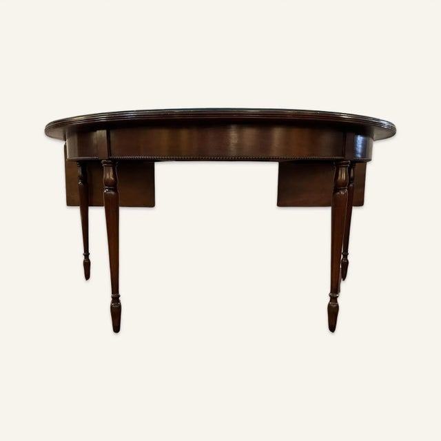 1950s horseshoe shaped walnut bar table with protective glass top. The glass covers all except two end leaves. The legs...