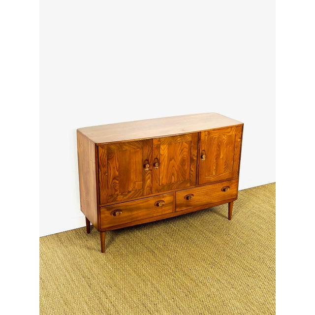 Vintage ercol scandinavian sideboard dating from the 1960s, featuring three storage doors with shelves and two drawers....