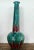 Standing 38 inches tall, this vintage ceramic vase makes a dramatic sculptural statement with a bulbous base, long slender...