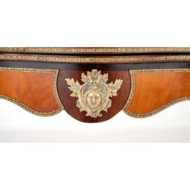 Good quality mahogany and rosewood french card table. This stunning french card table stands upon shaped legs with ormolu...