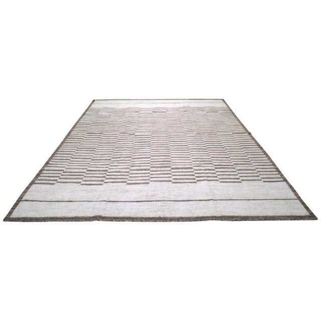 Moroccan Azilal hand knotted wool rug with abstract design.