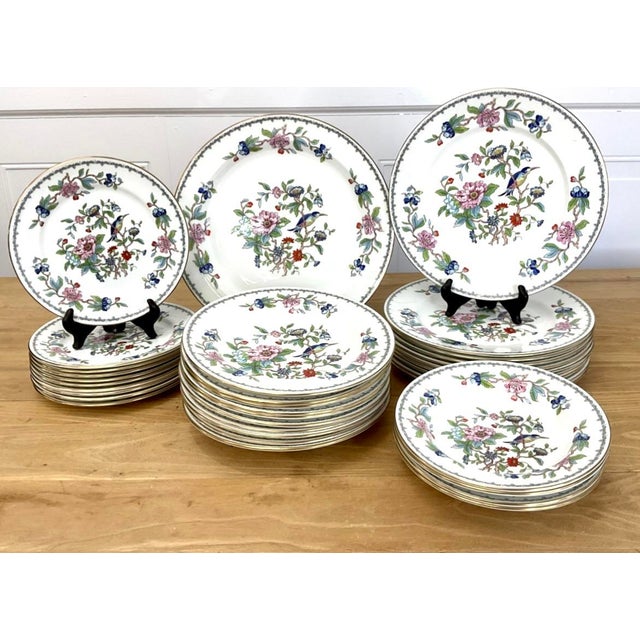 Gold-trimmed chinaware with a floral / botanical / bird pattern. 39 pieces total. Perfect for special occasions or...