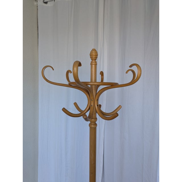 Vintage bentwood coat stand made from light-toned beech wood. The design features elegantly curved hooks, a circular...
