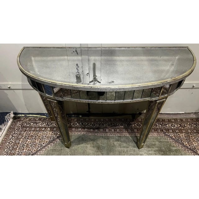 Distressed silver painted mirrored console table. the mirrors also have a slight distress to them which finishes the look....
