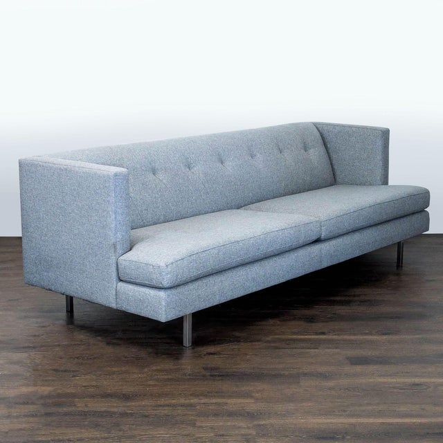 This CB2 3-seat sofa offers a clean, modern look with its soft grey fabric and button tufted backrest. Featuring straight...