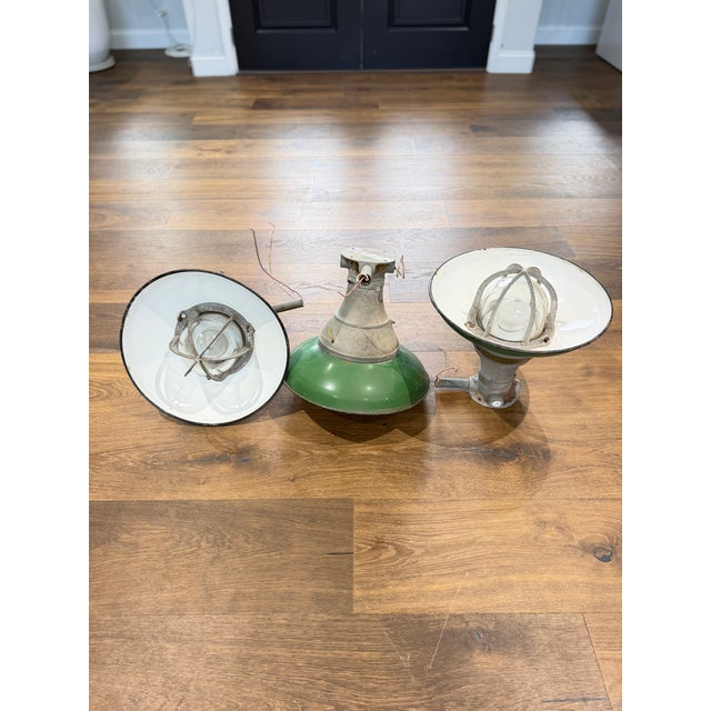 An exceptional and increasingly scarce matched set of three authentic Crouse-Hinds explosion-proof industrial pendant...