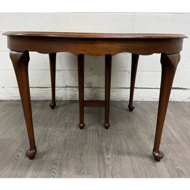 This is a beautiful vintage Queen Anne / Early American style oval dining table in solid cherry or cherry veneer with warm...