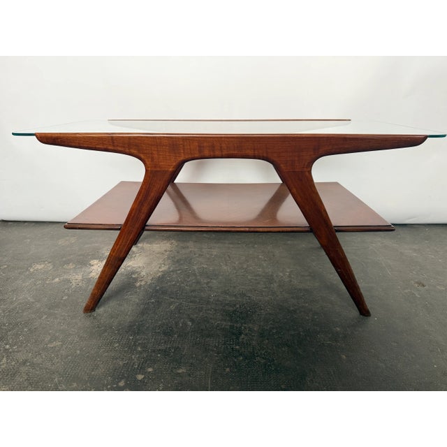 Coffee table by Italian designer Cesare Lacca for Cassina, not marked, made in the early 1960’s. Walnut veneer with a...