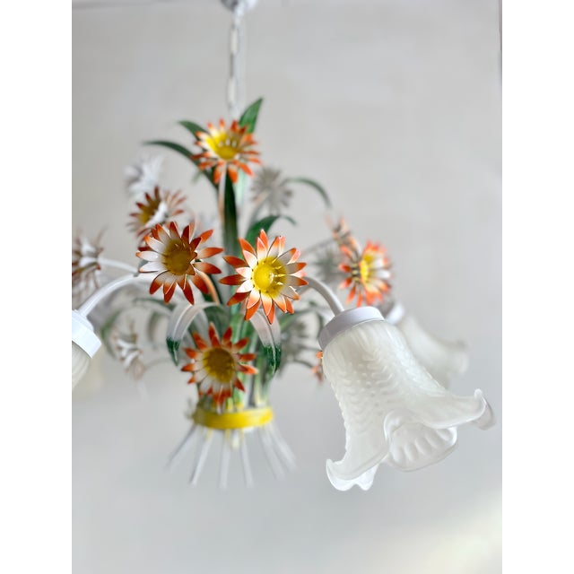 Vintage floral tole chandelier from the 1970s, hand-painted daisy flowers, green foliage, and five original frosted glass...