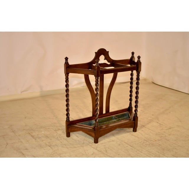19th century oak umbrella or cane stand from England. The back has lovely serpentine and scalloped details, which give it...