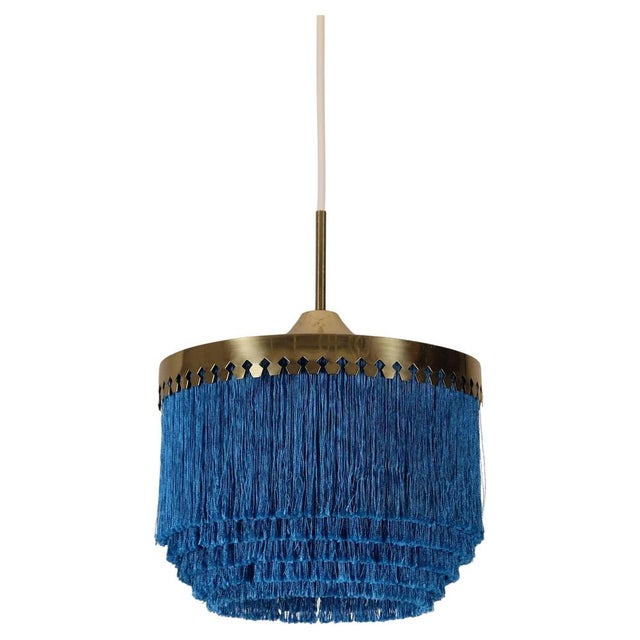 Blue fringes and brass. Produced by Hans-Agne Jakobsson, Markaryd, Sweden, 1960s. Height is adjustable. This piece is...