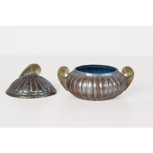 Early 20th century antique Chinese export lidded box with a lobed, hand-hammered copper body, sculptural brass scroll...