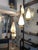 A floor lamp designed by Stilnovo in the 1950s, made of iron, brass, and glass. The base has three legs; the bottom one is...