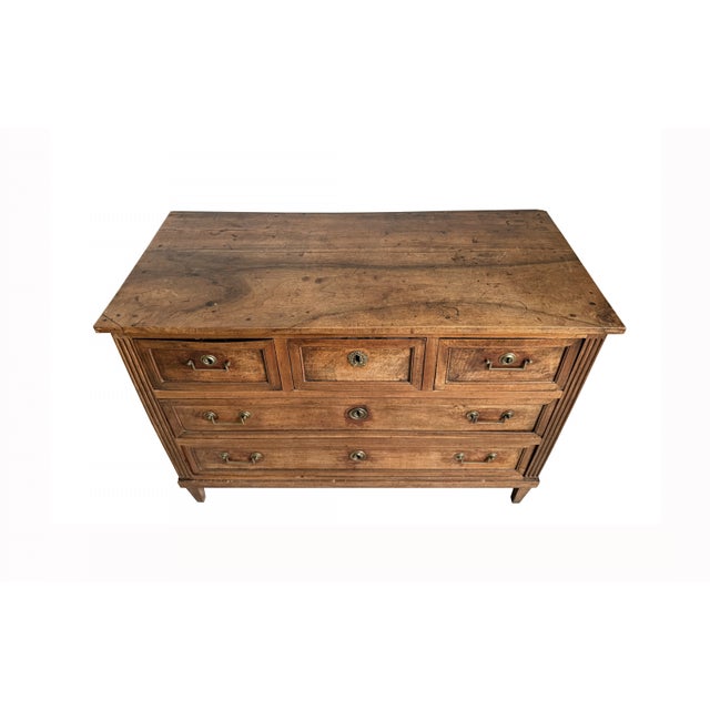 A refined early to mid-19th century French Provincial chest of drawers in the Louis XVI style, featuring a three-over-two...
