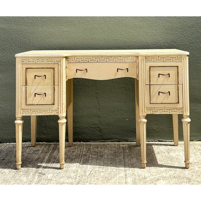 This elegant vintage vanity desk is a masterclass in Neoclassical design, perfectly capturing the timeless allure of the...