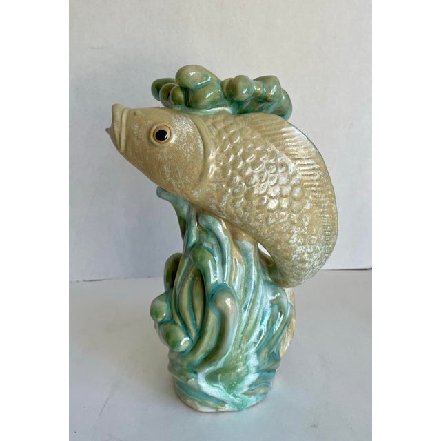 Here is a gorgeous vase made of majolica ceramic that features a lively fish in water. I love how the fish encircles the...