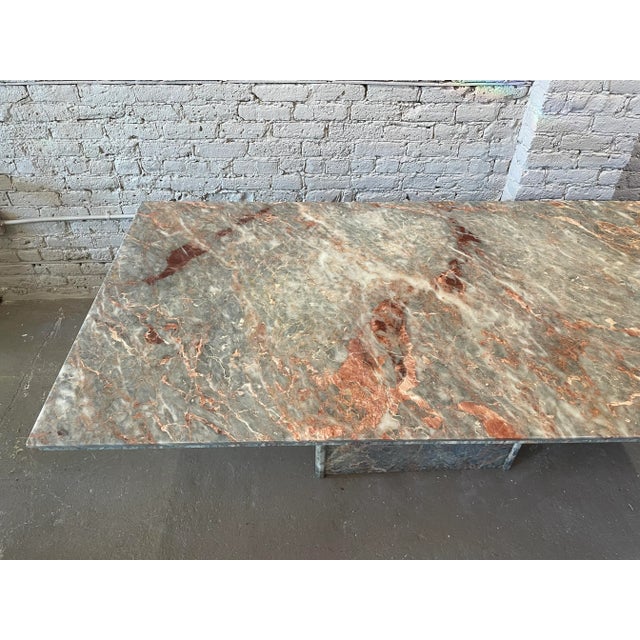 A classical marble with a muted, tonal palette of soft grey with tints of rose and teal, strongly accented by stunning...