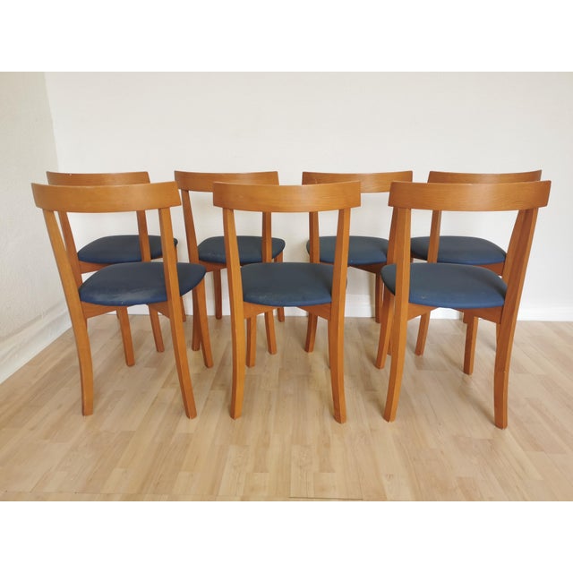 Vintage dining chairs are made in mid-century and scandinavian style from wooden base and vibrant blue fabric seat. Chairs...
