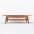 Vintage mid century sculpted teak coffee or cocktail table with woven magazine shelf, attributed to Arne Hovmand Olsen for...