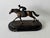 C.Charles signed bronze sculpture of jockey on race horse statue. The design of this sculpture draws inspiration from Art...