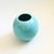 A vintage 1980s postmodern ceramic orb vase. High gloss light blue finish in a simple modern shape.