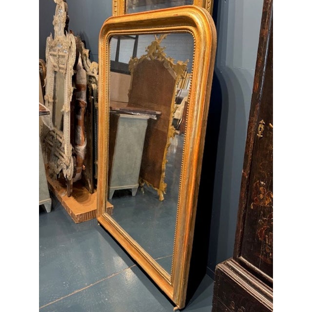 This 19th century mirror Louis Philippe mirror boasts a stunning gold frame with a line pattern, adding a touch of...