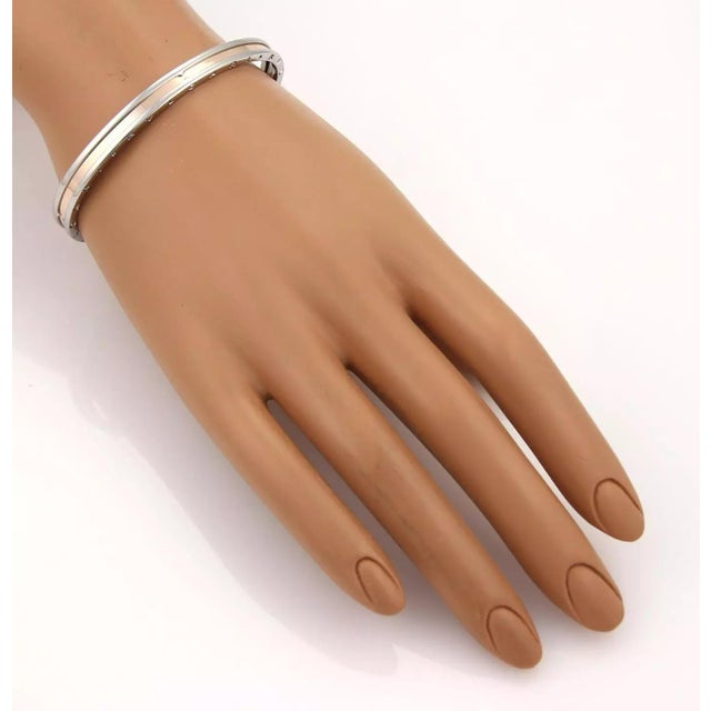 This elegant authentic cuff bracelet is by Bvlgari from the B Zero-1 collection. It is crafted from stainless steel and is...